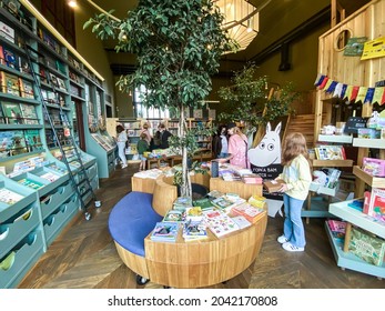 St. Petersburg, Russia, August 2021: A Red-haired Girl With Box In The Childrens Department Of A Modern Cozy Bookstore