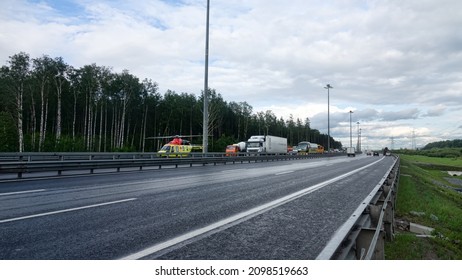 St. Petersburg, Russia - August 3 2019: Landing a medical helicopter on the highway after a car accident with wounded people and death. Aero-medical evacuation units or air ambulance