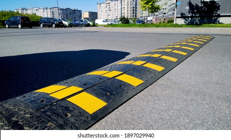 St. Petersburg, Russia - August 9, 2020: Speed Bump Near Apartment Building And School. Sleeping Policeman. Road Safety Regulations. Traffic Rules Concept. Car Parking. Real City Life. Tarmac. Shadow.