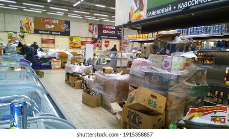 St. Petersburg, Russia - December, 2019: Bankruptcy of supermarket. Clutter, trash and scattered goods on dirty floor in the store. Mess, huge piles of cardboard boxes. Retail industry. Grocery store.
