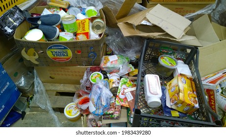 St. Petersburg, Russia - December, 2019: Pile Of Dirty Cardboard Boxes With Canned Food And Products. Clutter, Trash And Scattered Goods. Mess. Supermarket Waste. Grocery Store. Retail Industry. Shop.