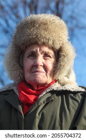 St. Petersburg, Russia - February 2, 2021. The Face Of An Old Woman In A Large Fur Hat Close-up. Severe Deep Facial Wrinkles