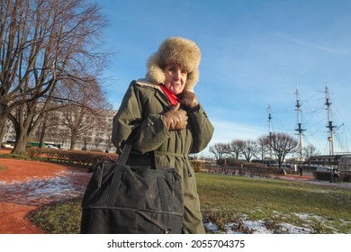 St. Petersburg, Russia - February 2, 2021. The Face Of An Old Woman In A Large Fur Hat Close-up. Severe Deep Facial Wrinkles