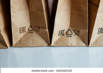 
St. Petersburg, Russia - February 20, 2020: Craft bags for tea or coffee, eco-friendly packaging for products. 
recycling sign