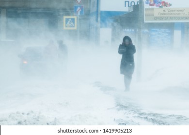 St. Petersburg, Russia is February, 2019 - The blizzard, strong wind, sleet, blurred silhouette of the people, tries to take cover from bad weather