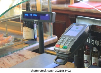 ST. PETERSBURG, RUSSIA - FEBRUARY 8, 2018: Credit Card Payment Machine in Retail Store. Small Payment Terminal at Cashier Station Checkout Lane Desk at the Grocery Shop.
