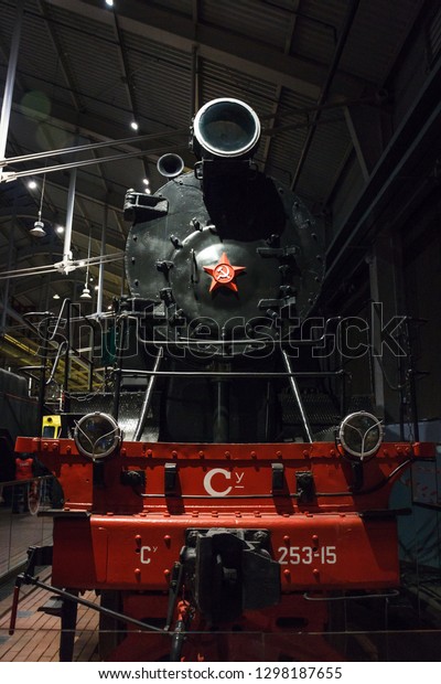 St. Petersburg, Russia - JANUARY 03, 2019: Museum of\
Railway Transport in St. Petersburg. Old train. Railways.\
Locomotive. Long train, many cars. Rails and sleepers, pillars\
along the roads. Travel ar