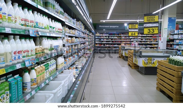 St. Petersburg, Russia - January 12, 2021: Top\
Russian Supermarket is one of largest players of retail industry in\
Russia. Shelves with milk, fresh dairy food. Aisle.  Grocery\
shopping. Discount.