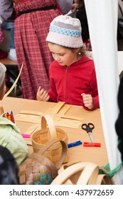 ST. PETERSBURG, RUSSIA - JULY 26, 2015: Unidentified Girl Learns To Weave Bast Basket On A City Fair. Master Class Teaching Children Folk Crafts Weaving A Basket