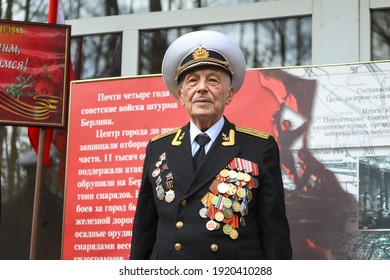 St. Petersburg, Russia - June 2, 2020: Old Man Retired Veteran Of World War II In A White Cap And Military Cap With Medals And Orders Of Military Awards. Portrait Of An Old Man With Wrinkles