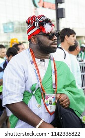 St. Petersburg, Russia - June 26, 2018: Supporter of Nigeria national football team, known as Super Eagles, at FIFA World Cup. Nigerian soccer fan before match. African man with traditional clothes.
