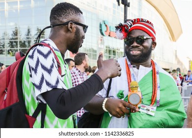 St. Petersburg, Russia - June 26, 2018: Two Supporter Of Nigeria National Football Team, Known As Super Eagles, FIFA World Cup. Nigerian Soccer Fans Before Match. African Men In Traditional Clothes. 