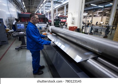 St. Petersburg, Russia - June 29, 2016: The operator of the bending machine controls the process of manufacturing the part that is used when assembling the body of the vehicle