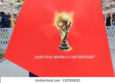 ST. PETERSBURG, RUSSIA - JUNE 7, 2018: FIFA World Cup Russia 2018 Icon with Golden Cup Close Up. Football Tournament Symbol, Champions Trophy Isolated on Red Background. Decorative World Cup Icon.