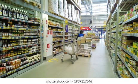 St. Petersburg, Russia - March 13, 2021: Top Russian Supermarket is one of largest players of retail industry in Russia. Shelves with food. Grocery store. Shopping trolley. Pallet with products. Shop.