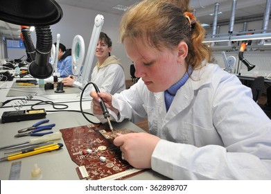 St. Petersburg, Russia - March 18, 2015: Students of vocational school in a workshop  of electrical engineering. Study and soldering of simple electric circuits.