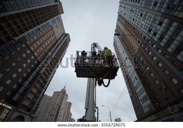 St. Petersburg, Russia - March 28, 2018: A car\
combined fire lift with a cradle between two high-rise buildings.\
Pushed to save people from high floors during an emergency fire\
brigade is at work.