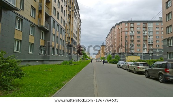 St. Petersburg, Russia - May, 2019: New residential\
district. Buildings exterior. Cars parked. Real estate investing.\
Housing affordability and development. Sales and rental property\
trends. City.
