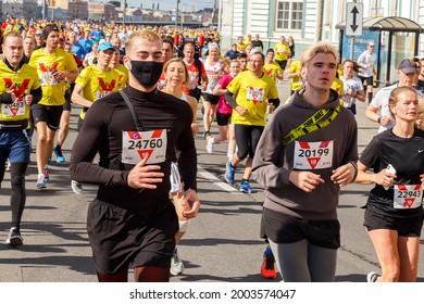 St. Petersburg, Russia - May 30, 2021: An Athlete Runs In A Medical Mask At A Mass Sports Event.