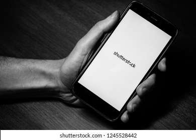 St. Petersburg, Russia, November 22 2018. Photostock Shutterstock LOGO on the smartphone screen close up. gadget in hand