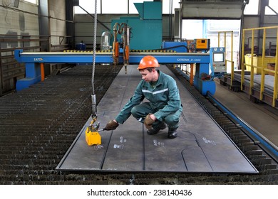 St. Petersburg, Russia - October 10, 2014: worker moves rectangle powerful permanent magnetic lifter,  industrial process for metalworking plant, metallurgical engineering.
