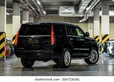 St Petersburg, Russia - October 17, 2021: Cadillac Escalade IV Rear View, Three Quarters View, Taillight On