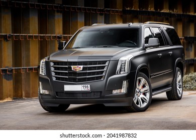 St Petersburg, Russia - September 15, 2021: Cadillac Escalade IV ESV DEPP Limousine Front Three Quarters Urban Landscape View Orange Tone