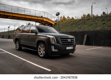 St Petersburg, Russia - September 15, 2021: Cadillac Escalade IV ESV DEPP Limousine Front Three Quarters Urban Landscape View Orange Tone