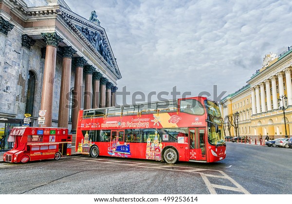 ST. PETERSBURG, RUSSIA-9 \
JANUARY, 2016: excursions the bus the bus at an isakiyevsky\
cathedral. The tourist bus - ideal transport for tourists to St.\
Petersburg.
