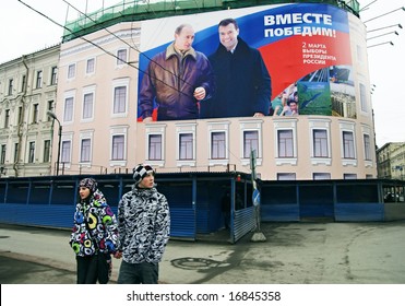 ST PETERSBURG, RUSSIA-MARCH 02, 2008: Citizens Pass By Banner For Presidential Election Campaign Showing President Vladimir Putin And Candidate Dmitri Medvedev. Slogan Reads: Together We Will Win