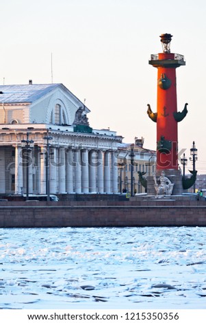 St. Petersburg in the winter. View from the frozen Neva River to the Rostral Column and the Old Stock Exchange (Bourse) building on Vasilyevsky Island