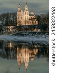 St. Sophia Cathedral in the city of Polotsk and its reflection in the Western Dvina river on a warm winter evening.