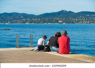 ST TROPEZ, FRANCE - OCTOBER 24, 2017: Unknown Family Relaxing On Pier In The St. Tropez Bay