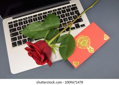 St Valentines Day Composition: Fresh Rose And Beautiful Red Valentine On The Open Keyboard Of New Laptop