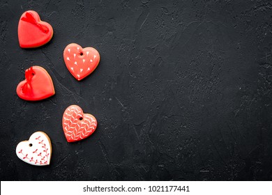 St Valentine's Day cookies in shape of heart on black background top view copy space