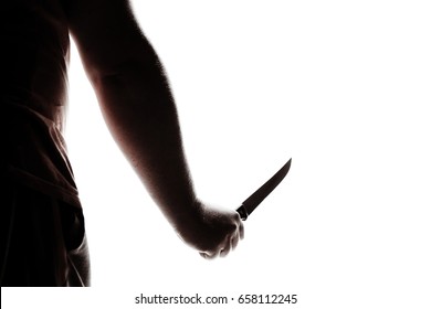 Stabbing attack. Hand with a knife. Murder with a knife.