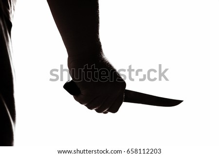 Stabbing attack. Hand with a knife. Murder with a knife.