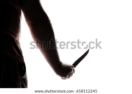 Stabbing attack. Hand with a knife. Murder with a knife.