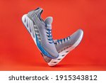 Stability and cushion running shoes. New unbranded running sneaker or trainer on orange background. Men