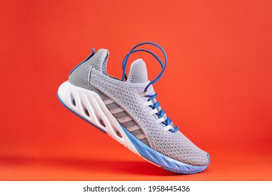Stability and cushion running shoes. New unbranded running sneaker or trainer on orange background. Men's sport footwear. - Shutterstock ID 1958445436