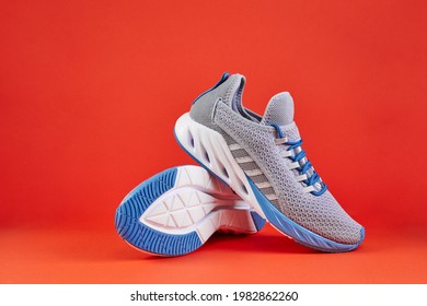 Stability and cushion running shoes. New unbranded running sneaker or trainer on orange background. Men's sport footwear. Pair of sport shoes. - Shutterstock ID 1982862260