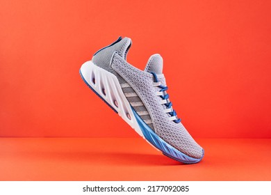 Stability and cushion running shoes. New unbranded running sneaker or trainer on orange background. Men's sport footwear. Pair of sport shoes. - Powered by Shutterstock