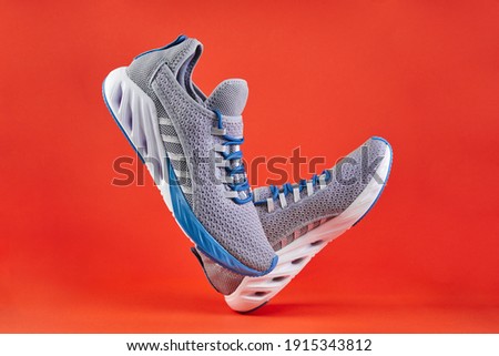 Stability and cushion running shoes. New unbranded running sneaker or trainer on orange background. Men's sport footwear. Pair of sport shoes. Stock foto © 