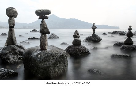 Stability nature meditation background. Calm water and stone balance zen tower. Nature photography  