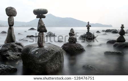 Stability nature meditation background. Calm water and stone balance zen tower. Nature photography  
