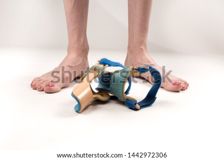 stabilizing orthosis for the correction of the big toe on the woman legs when hallux valgus, 2 legs, close-up isolated, white background