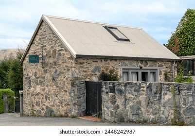 The Stable, a stone edifice from 1870, stands in Queenstown as a testament to historical architecture, with its rustic stone walls and classic design, encapsulating the essence of the era.