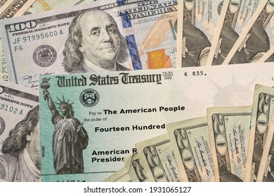 Stack of 20 dollar bills with US Treasury illustrative check to illustrate American Rescue Plan Act of 2021 payment on cash background - Shutterstock ID 1931065127
