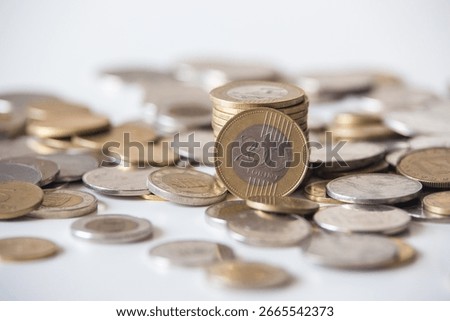 Stack of 200 Forint coins among other Forint coins scattered