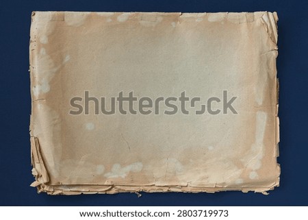 Stack of aged papers with torn edges isolated on dark background, stains, folds, archive document surface, old stained paper backdrop. Natural vintage paper background, history, archive, copy space